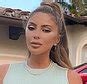 Larsa Pippen sunbathes topless in a thong and wears lacy pink。